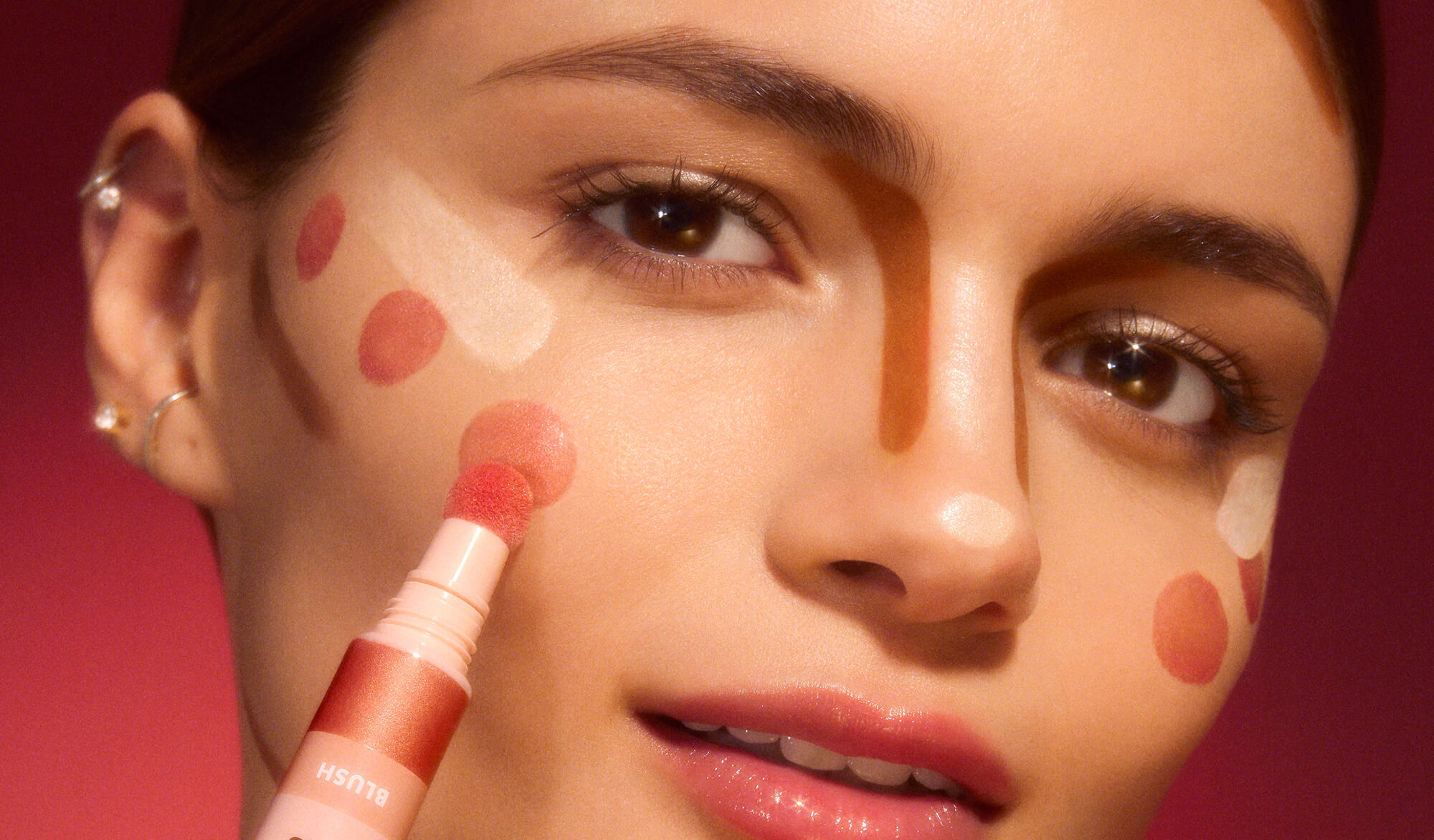 Woman with the beauty wands marked on her face to indicate where to apply