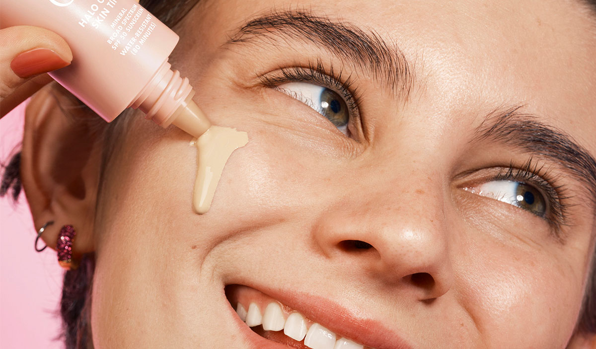 Model Applying Skin Tint