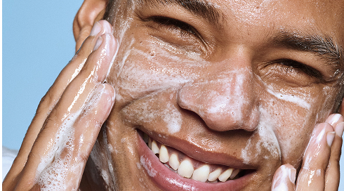 Model applying holy hydration clean freak daily cleanser on face