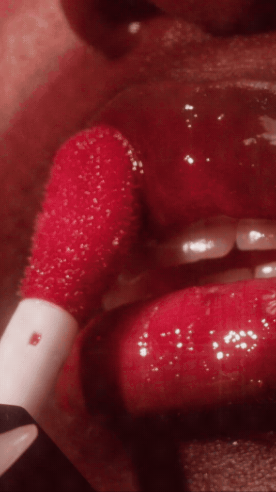 Model applying e.l.f. Glow Reviver Lip Oil