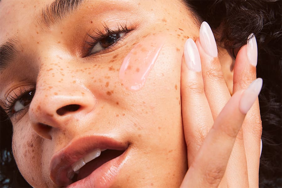 Model applying e.l.f. skincare