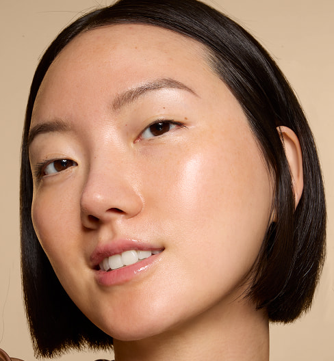 Model wearing e.l.f. Bronzing Drops