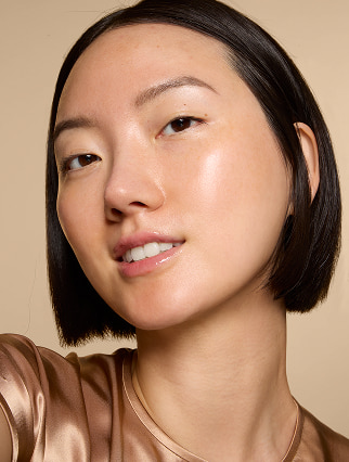 Model wearing e.l.f. Bronzing Drops