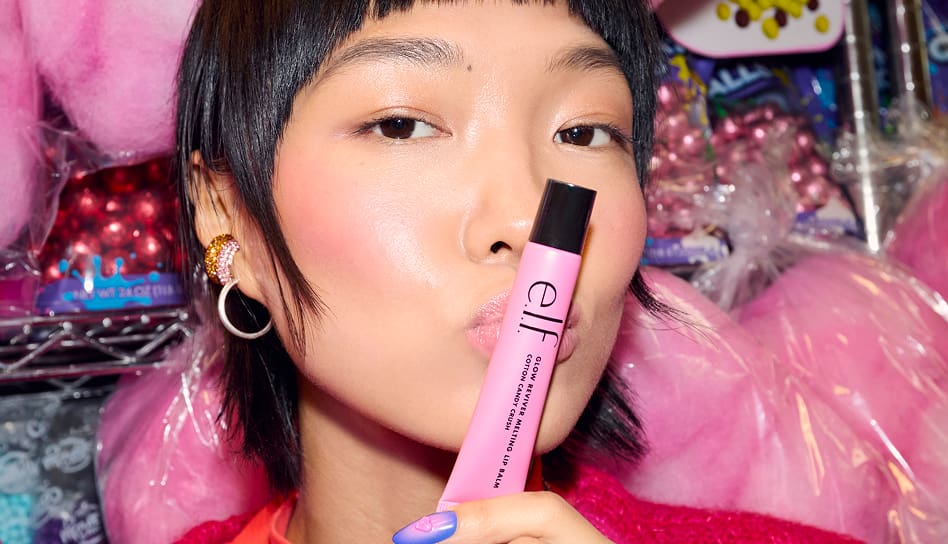 Model wearing Glow Reviver Melting Lip Balm, shade Cotton Candy Crush